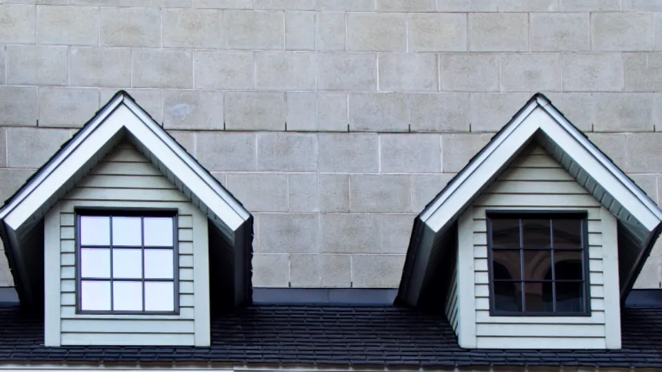 A grey roof with dormer windows on a house